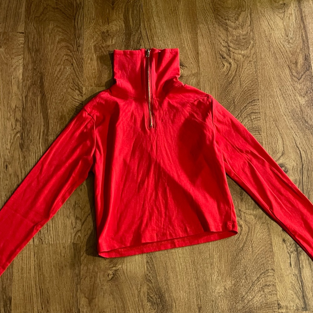 Long sleeve crop top. Can be worn with zipper down.